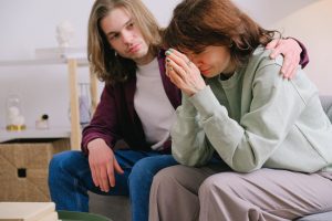 Siblings consoling each other